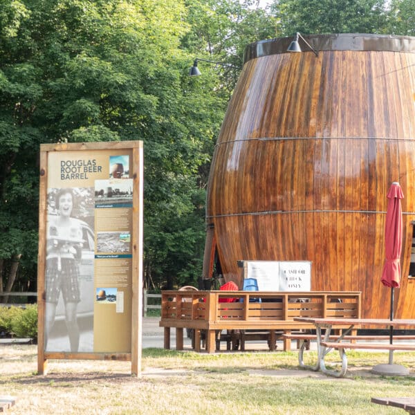 A view of the Root Beer Barrel in Douglas. with an interpretive sign to the left